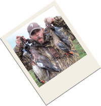 a man holding up a photo of ducks